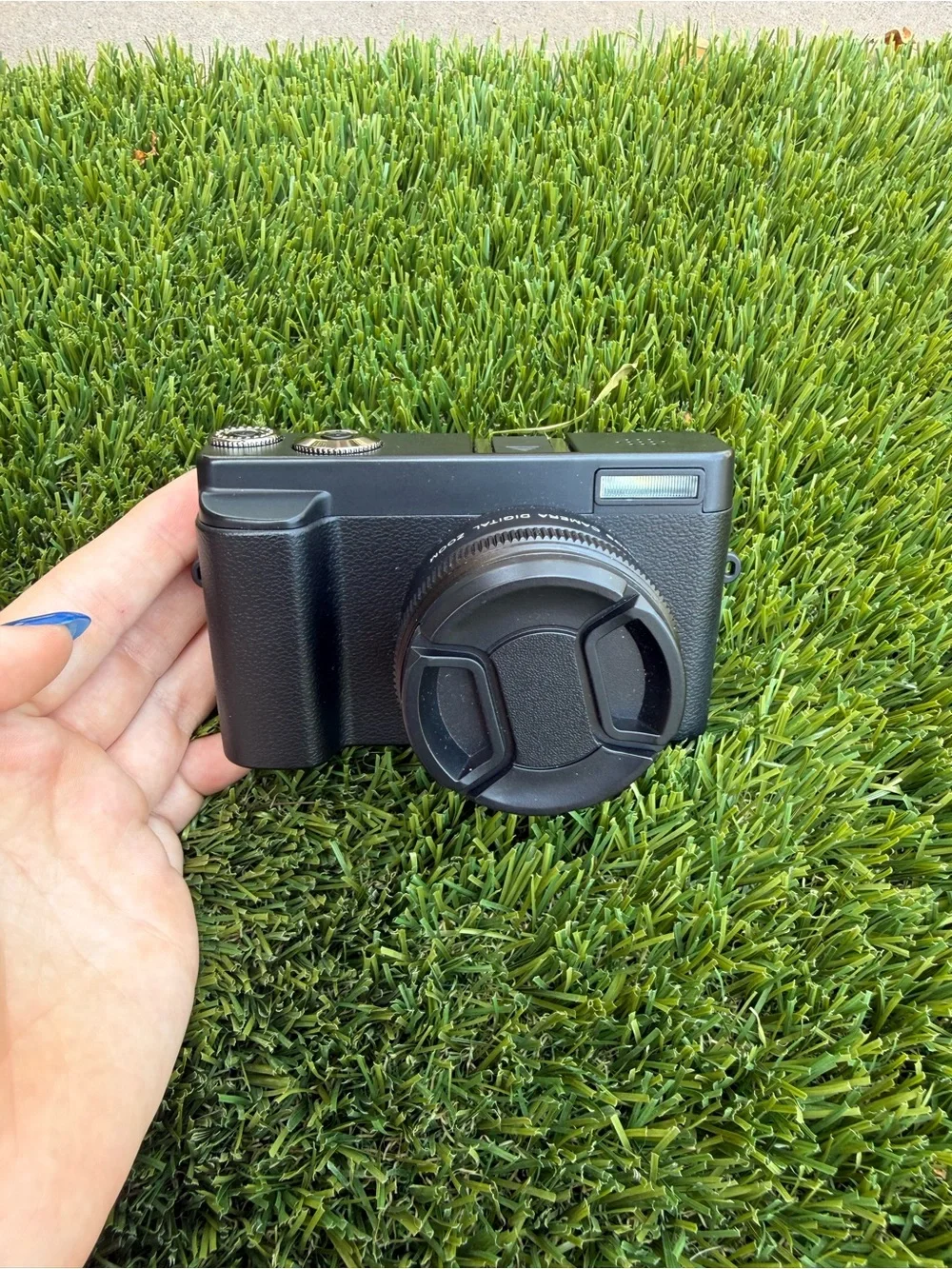 Compact Black Digital Camera with Accessories and Lens Cap
